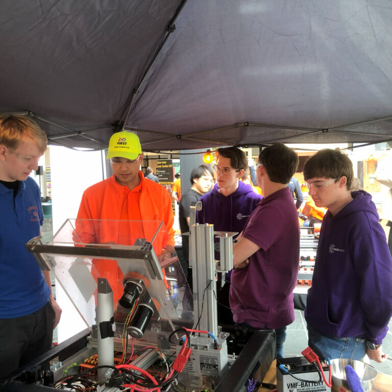 The robot is being checked by an organizer