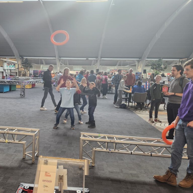 A kid catches a NOTE shot by the robot